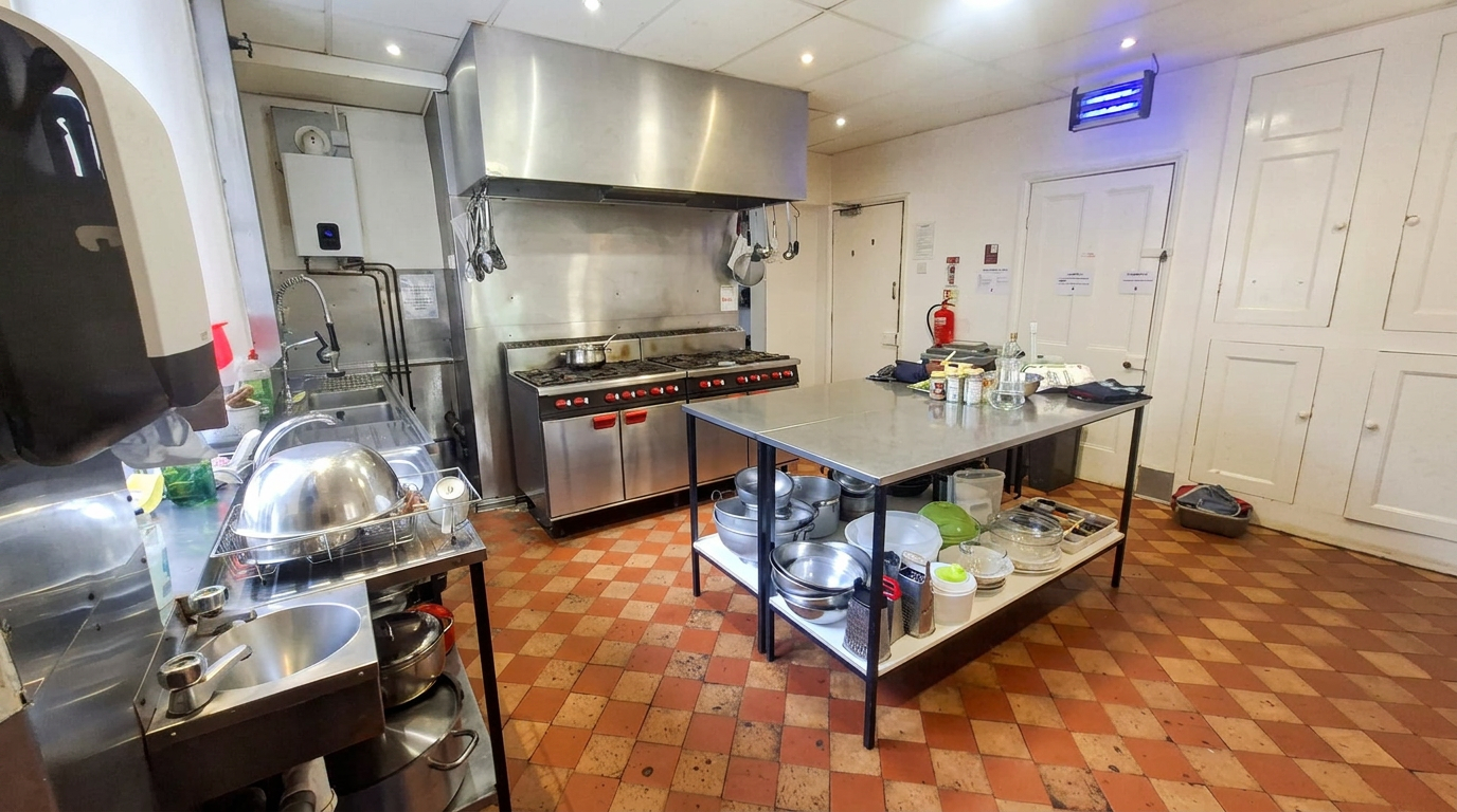 Well-equipped commercial kitchen with gas range